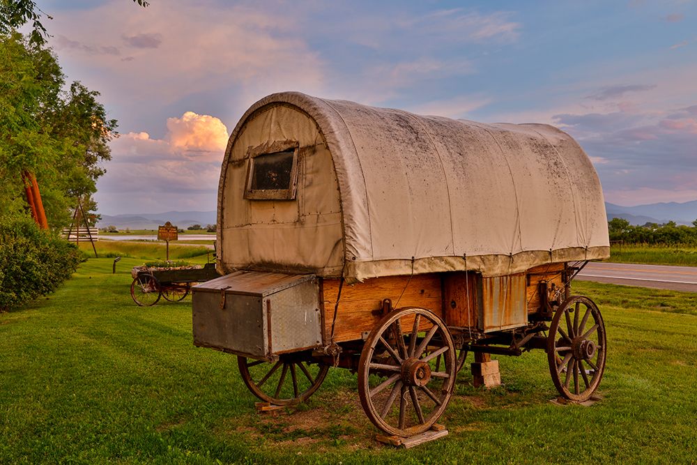 USA, Montana, Allentown. Evening light on covered wagon with evening sunset colors